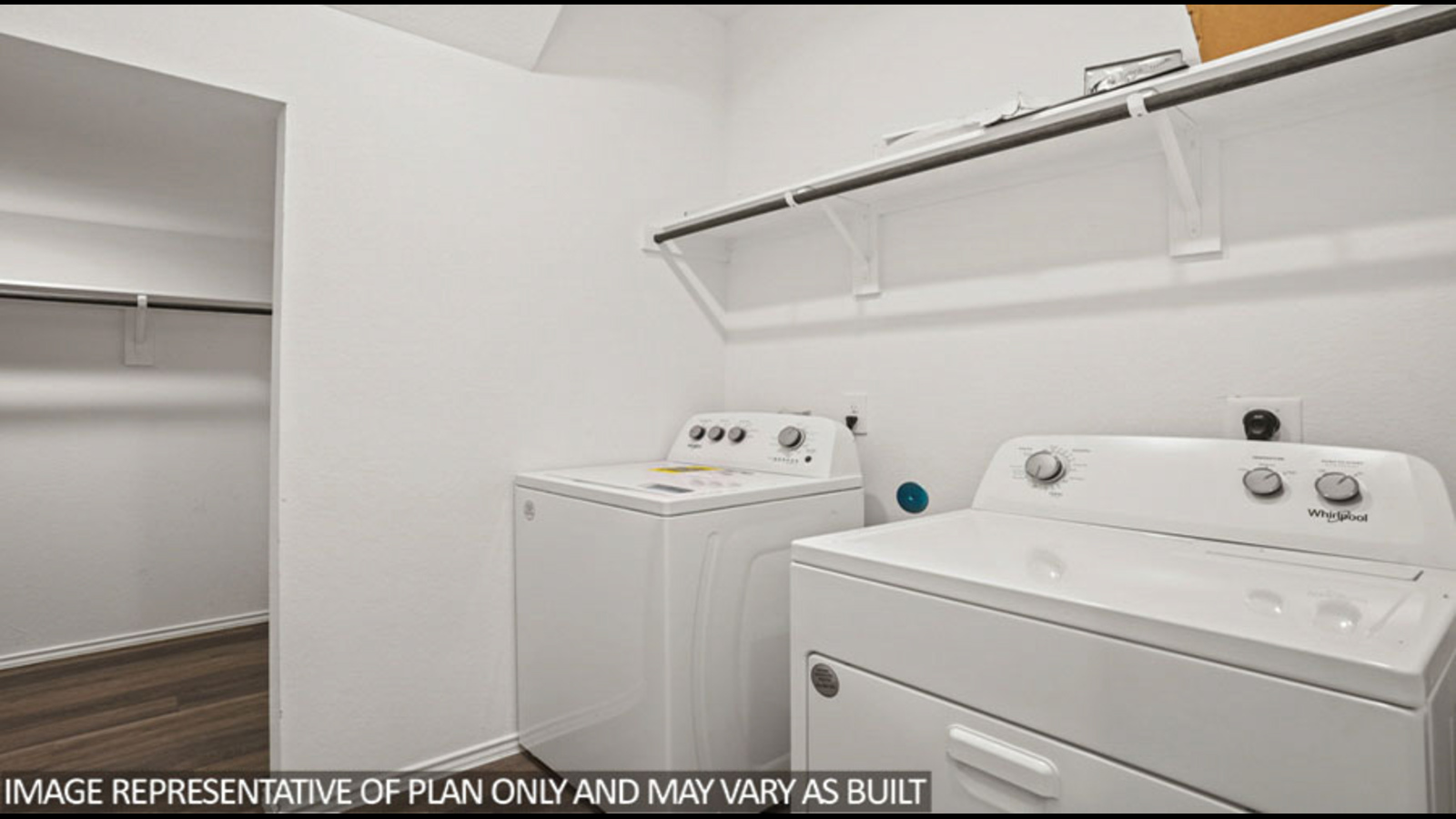 Laundry room with white walls and vinyl wood flooring.