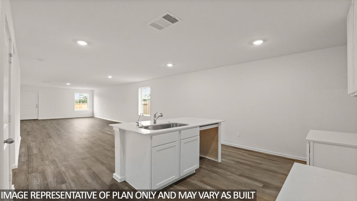 Open concept living and dining area with vinyl flooring and quartz countertops