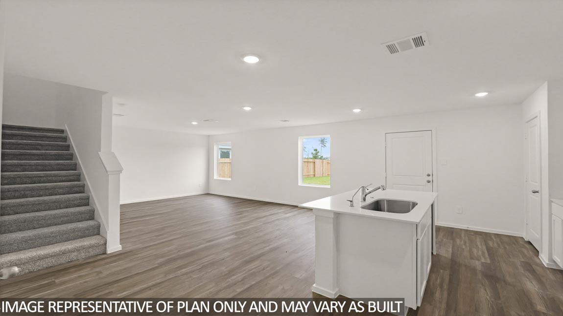 open cncept livving and dining area with vinyl flooring, quartz ciountertops, and large windows