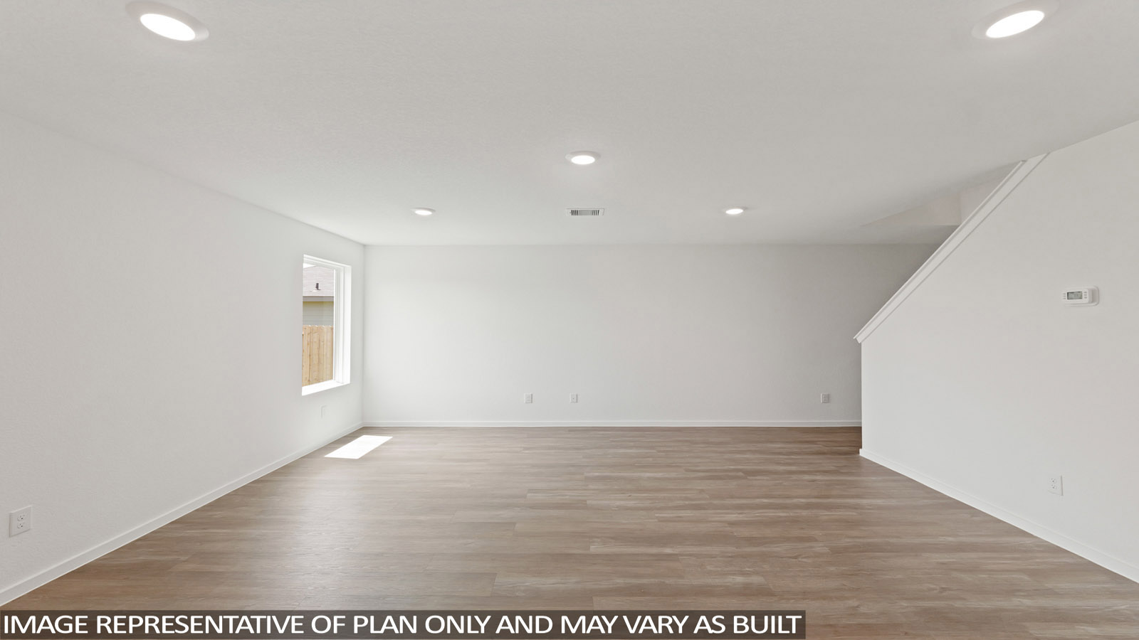 open concept living and dining area with large windows, quartz countertops and atainless steel appliances in Katy, TX