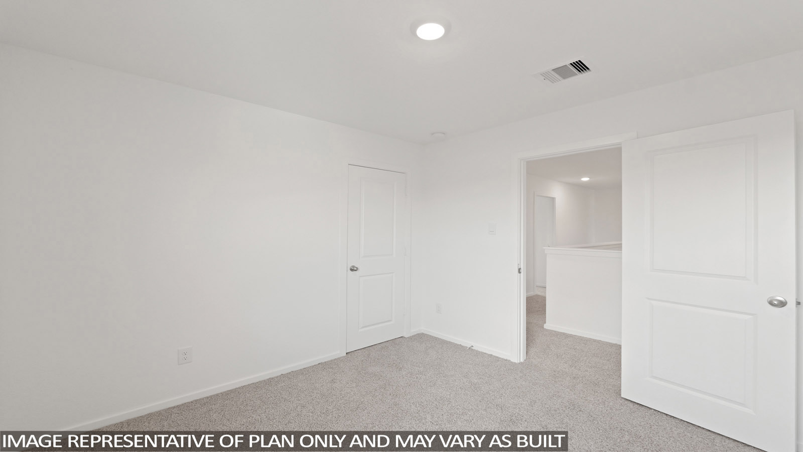 Secondary bedroom with carpet flooring