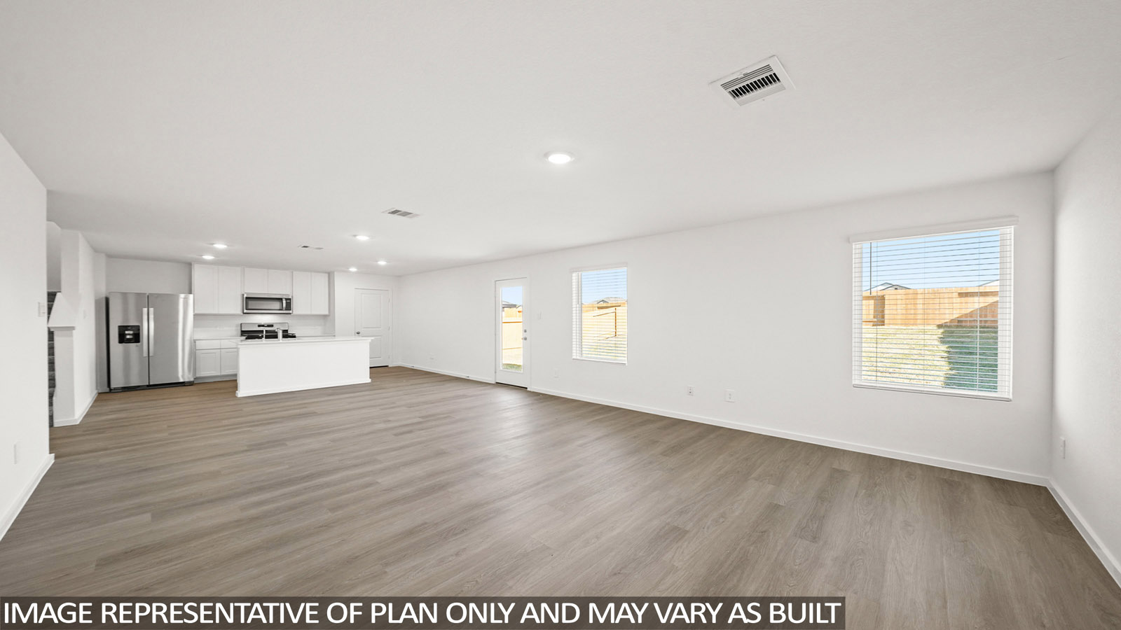 open concept living and dining area with vinyl flooring, quartz countertops, and stainless steel appliances