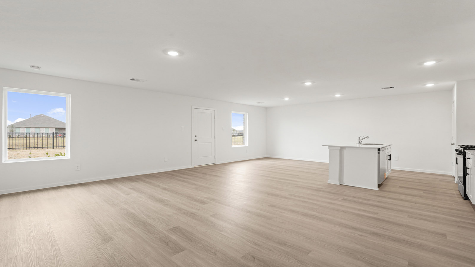 open concept living and dining area with vinyl flooring, quartz countertops, and large windows