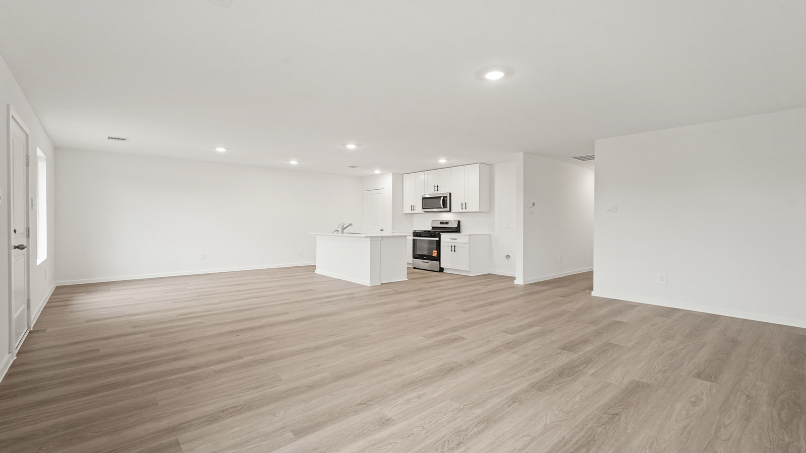 open concept living and dining area with vinyl flooring, quartz countertops, and large windows