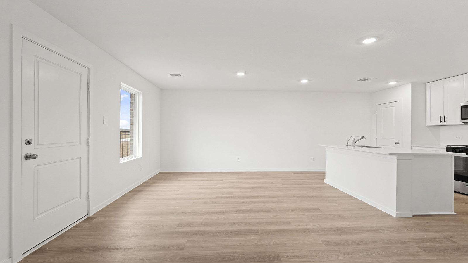 open concept living and dining area with vinyl flooring, quartz countertops, and large windows