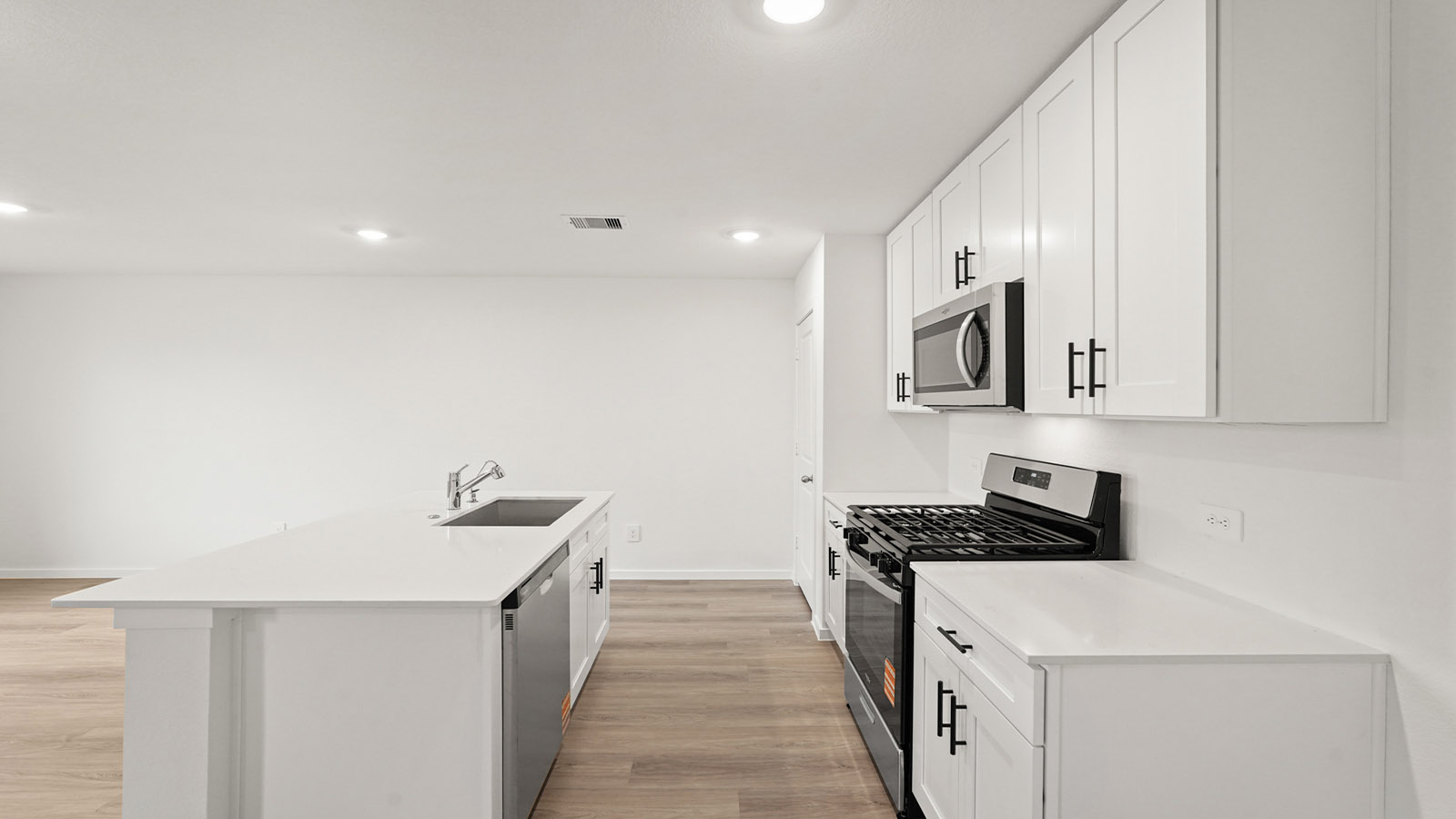 open concept living and dining area with vinyl flooring, quartz countertops, and large windows