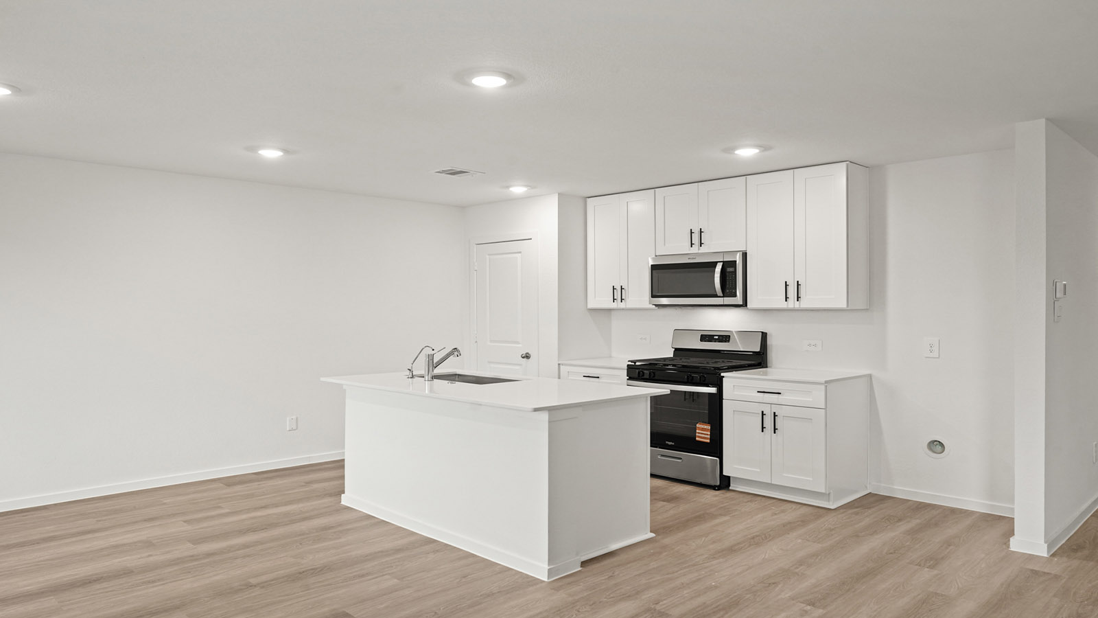 open concept living and dining area with vinyl flooring, quartz countertops, and large windows