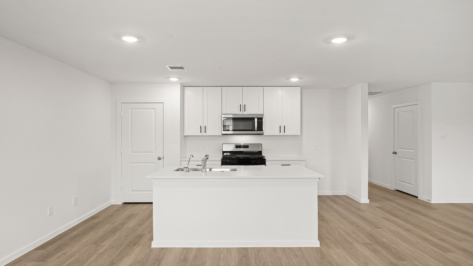 open concept living and dining area with vinyl flooring, quartz countertops, and large windows