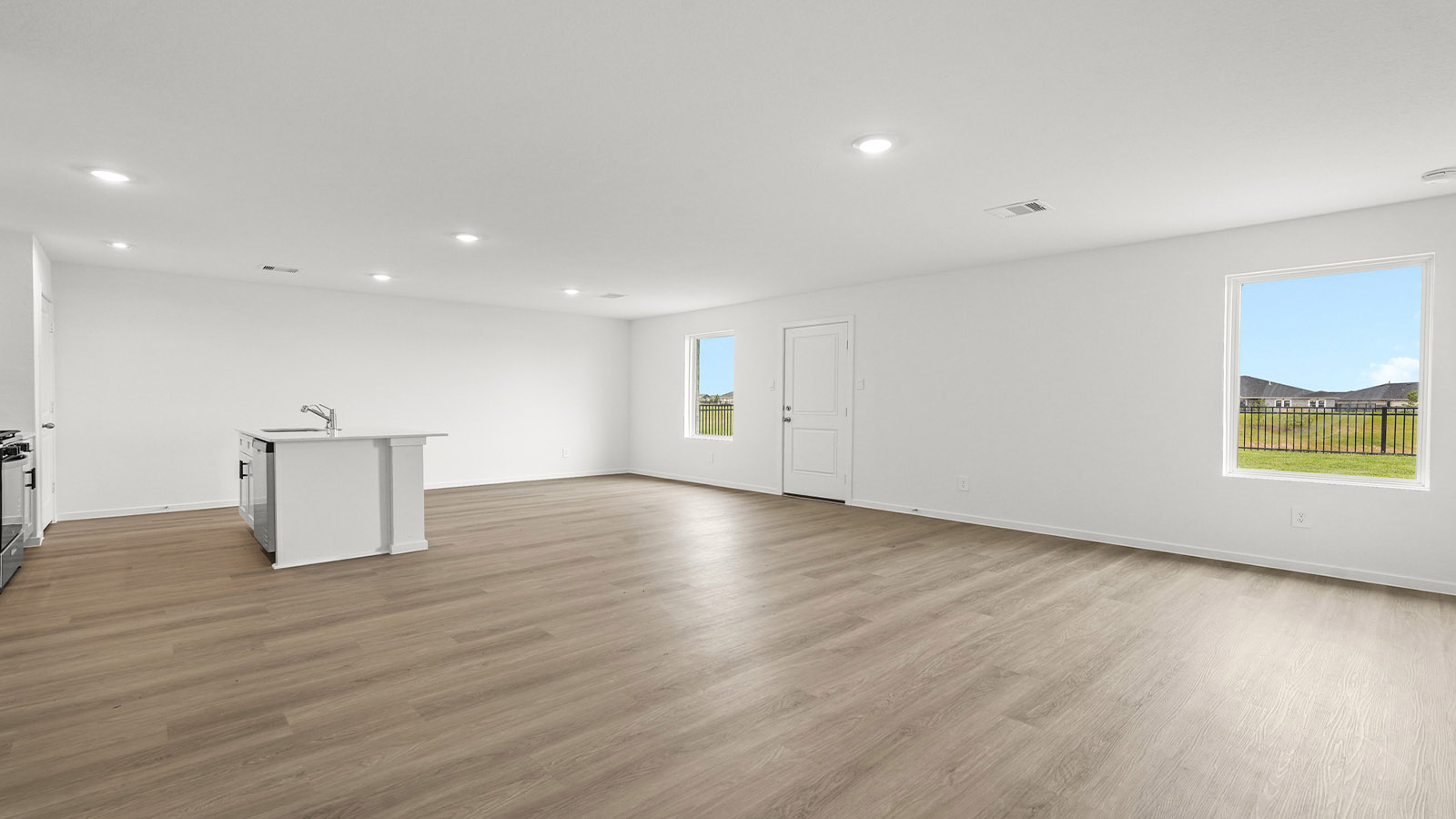open concept living and dining area with vinylflooring, quartz countertops, and large windows 3028 Nori Shores Drive