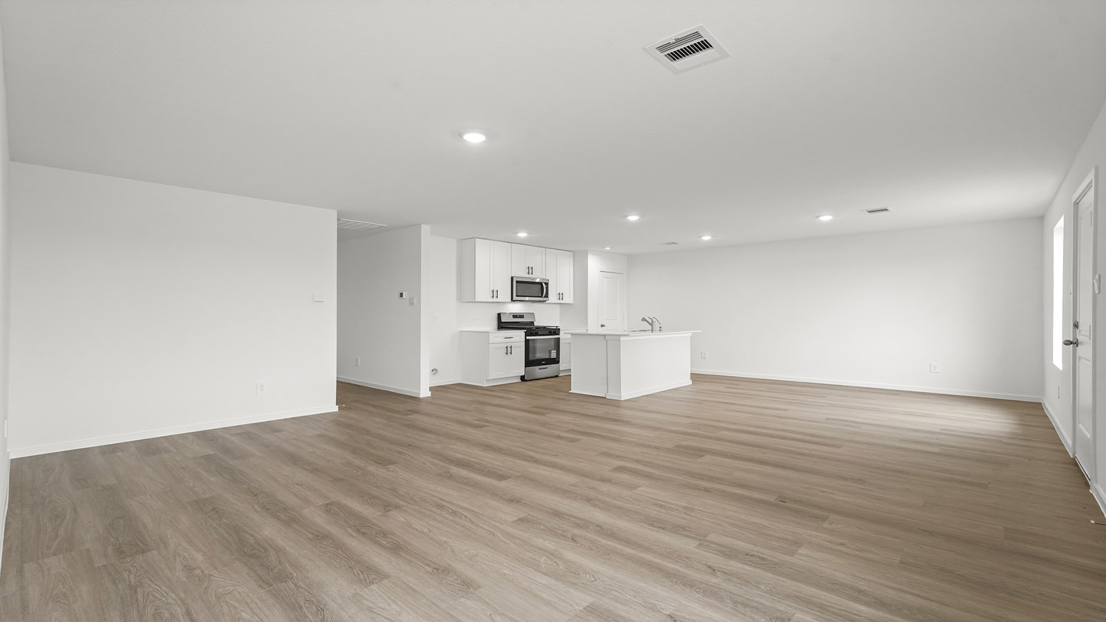 open concept living and dining area with vinylflooring, quartz countertops, and large windows 3028 Nori Shores Drive