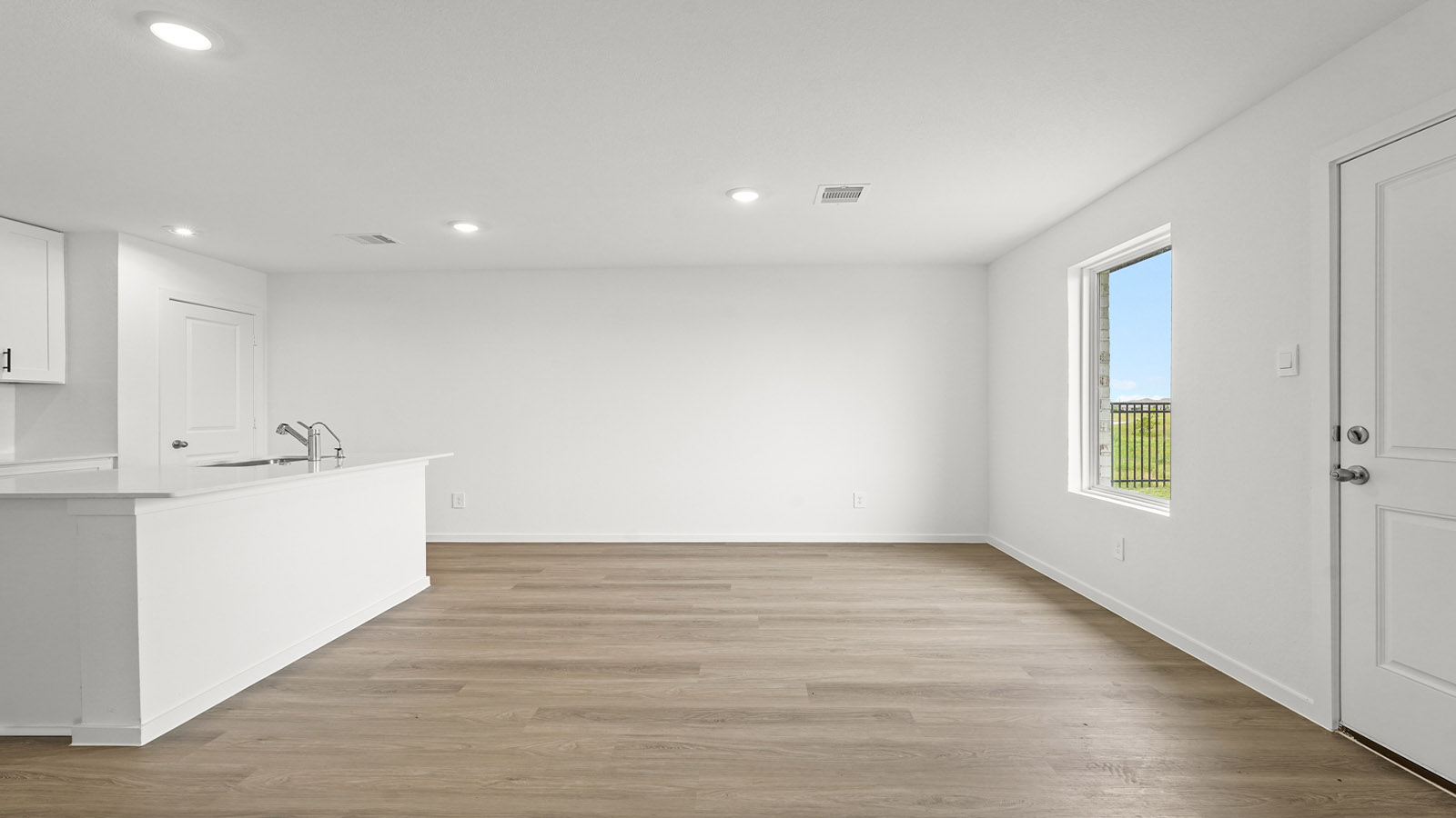 open concept living and dining area with vinylflooring, quartz countertops, and large windows 3028 Nori Shores Drive