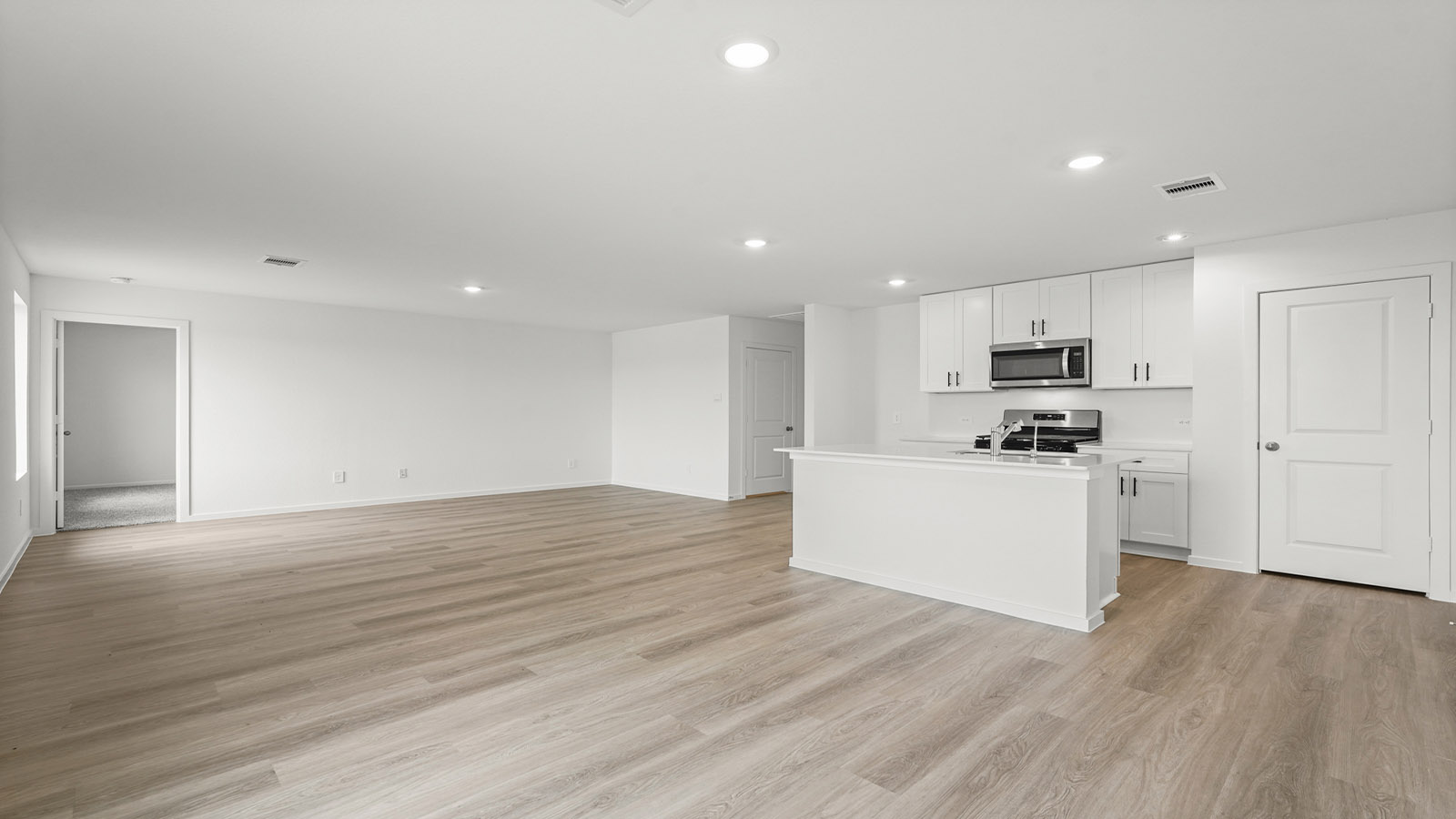 open concept living and dining area with vinylflooring, quartz countertops, and large windows 3028 Nori Shores Drive