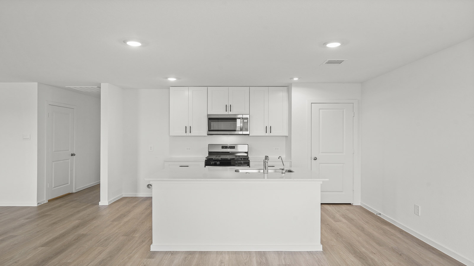 open concept living and dining area with vinylflooring, quartz countertops, and large windows 3028 Nori Shores Drive