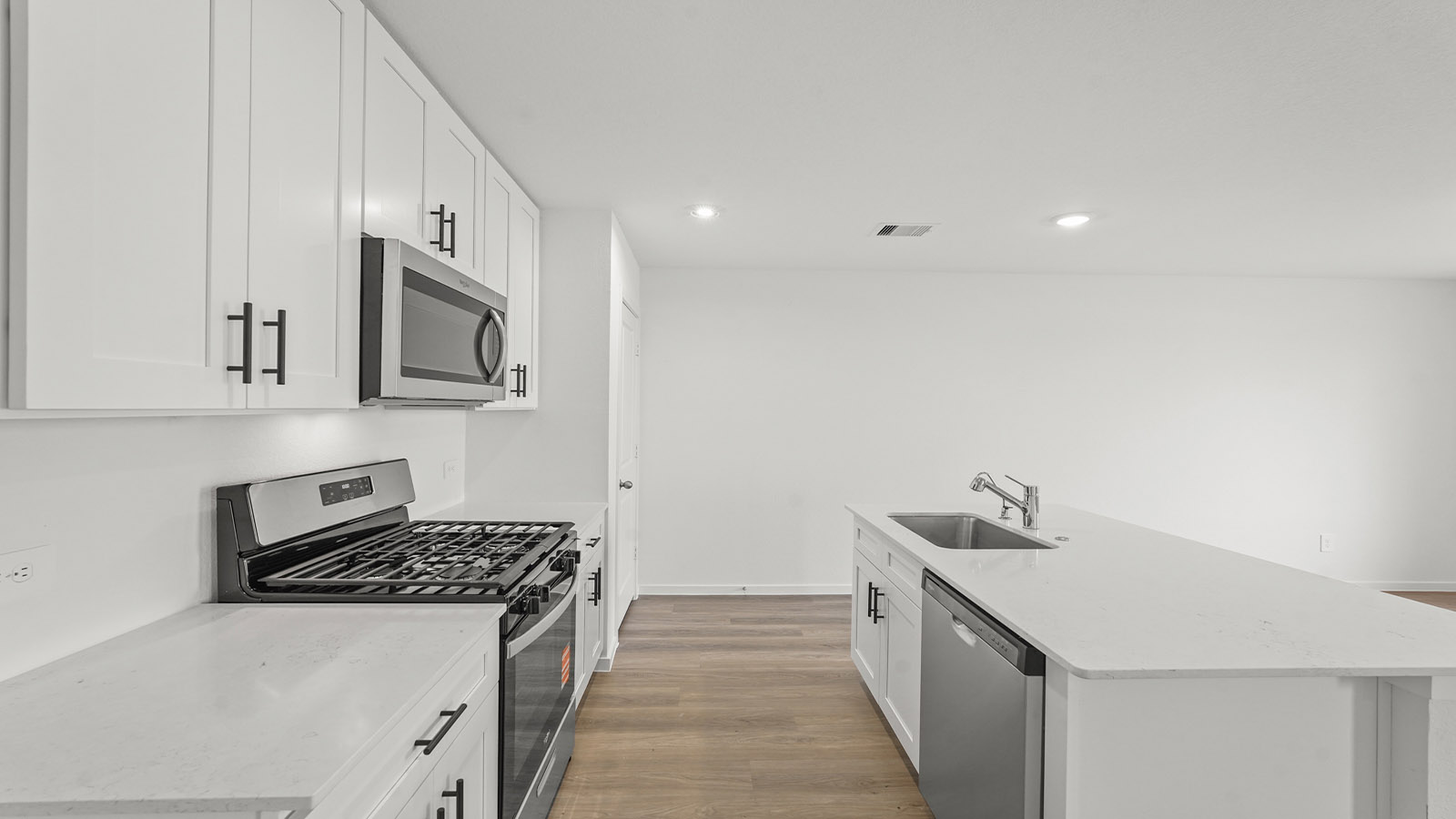 open concept living and dining area with vinylflooring, quartz countertops, and large windows 3028 Nori Shores Drive