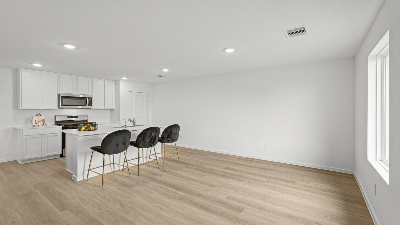 open concept living and dining area with vinyl flooring and large windows