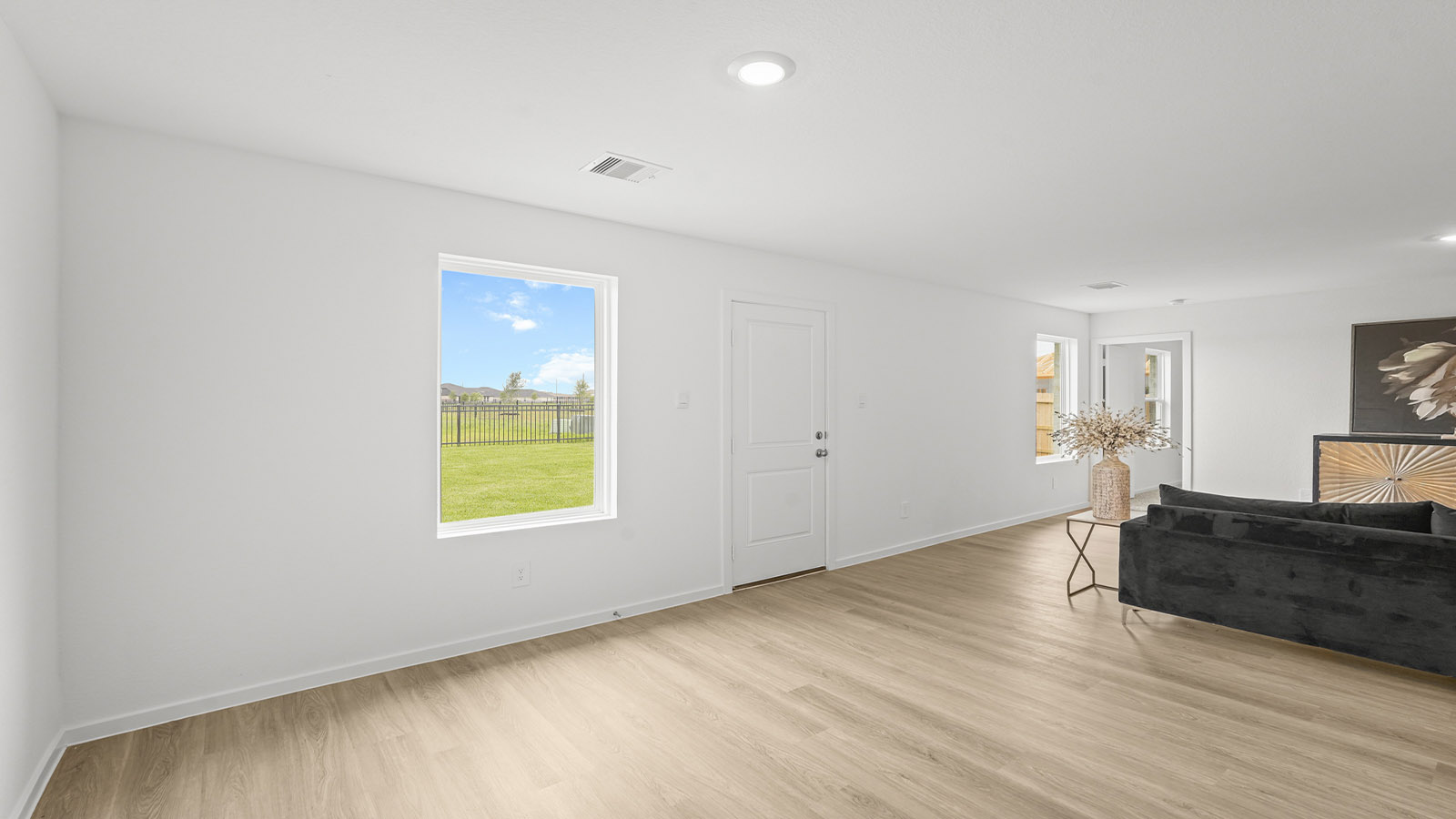open concept living and dining area with vinyl flooring and large windows