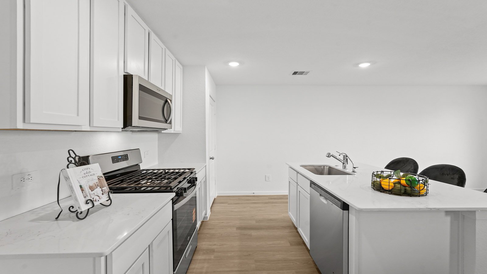 open concept living and dining area with vinyl flooring and large windows