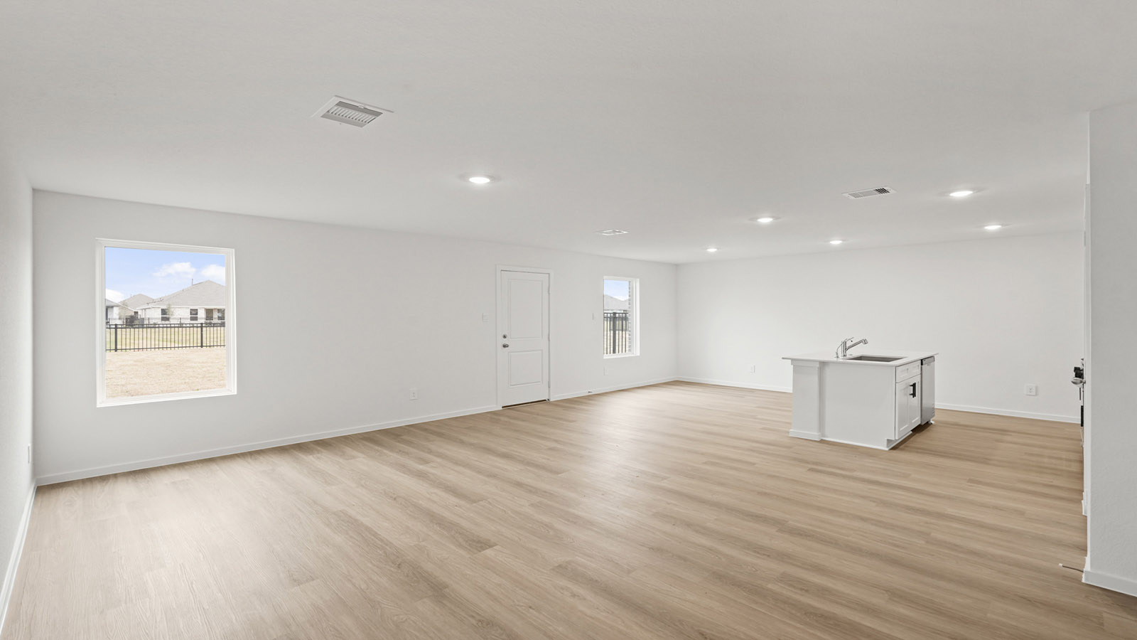 open concept living and dining area with vinyl flooring, quartz countertops, and large windows