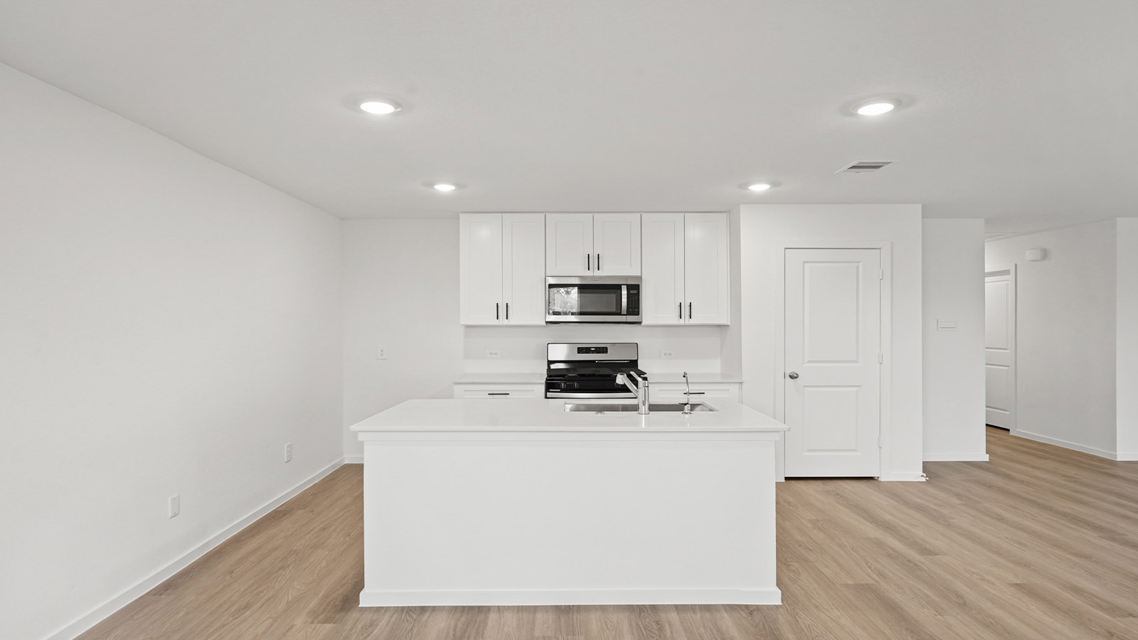 open concept living and dining area with vinyl flooring, quartz countertops, and large windows