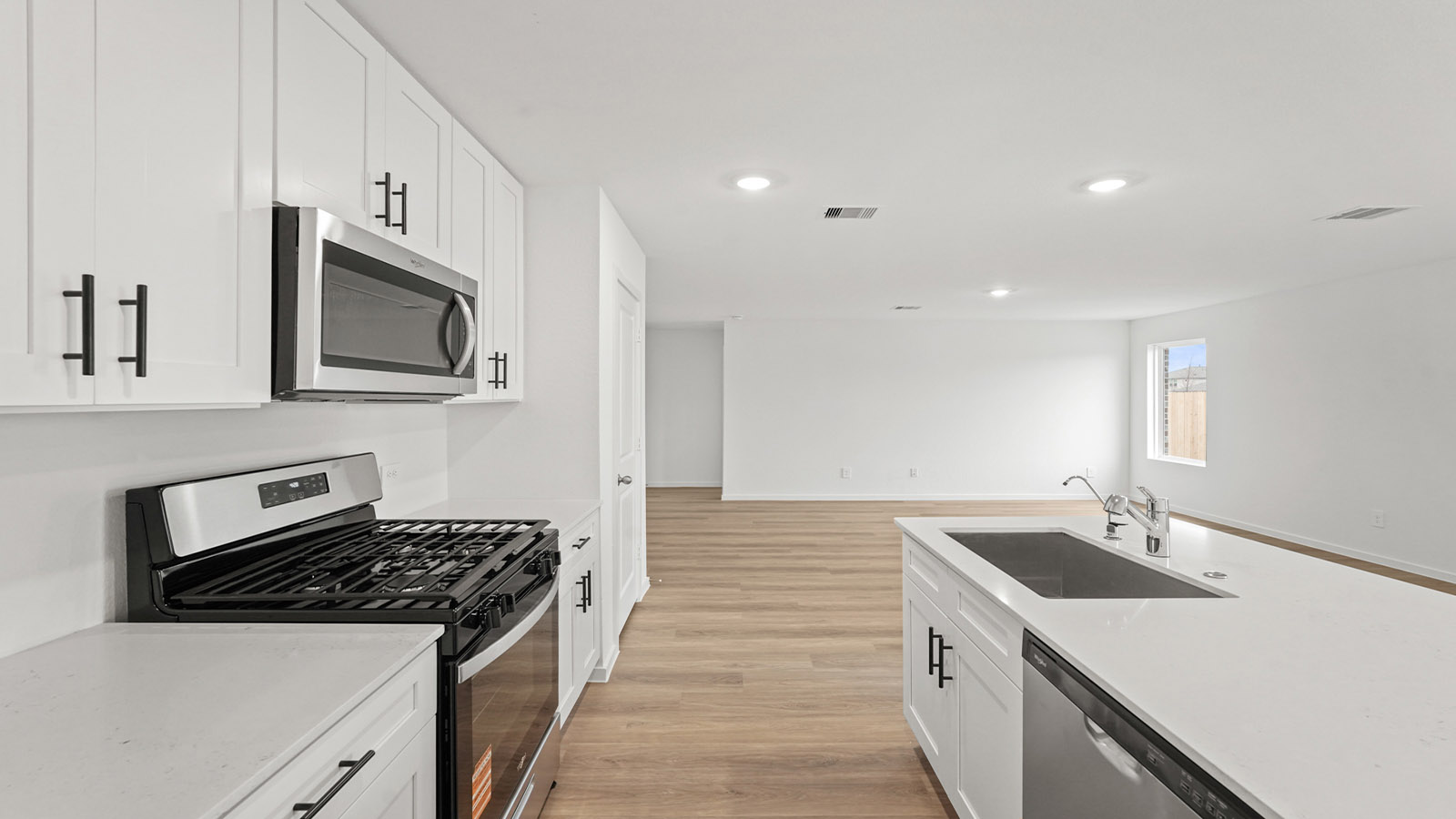 open concept living and dining area with vinyl flooring, quartz countertops, and large windows