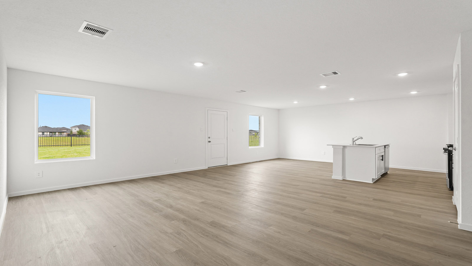 open concept living and ding area with vinyl floring, quartz countertops, and large windows