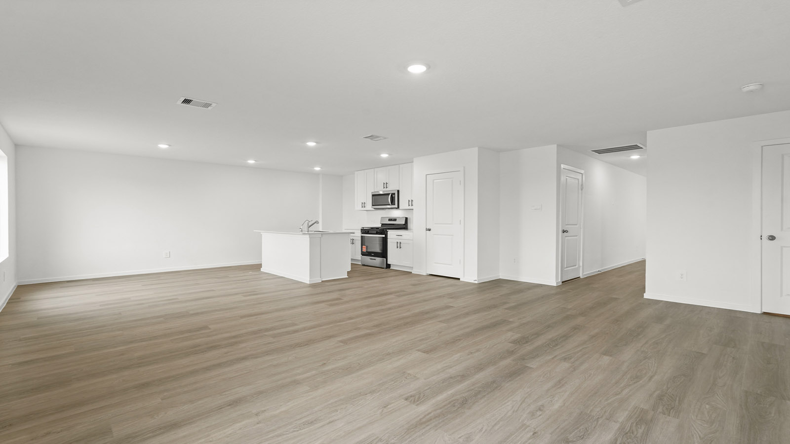 open concept living and ding area with vinyl floring, quartz countertops, and large windows