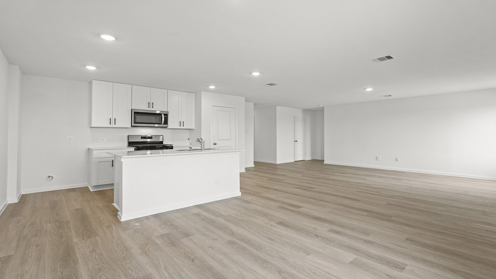 open concept living and ding area with vinyl floring, quartz countertops, and large windows