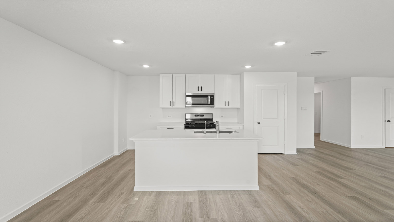 open concept living and ding area with vinyl floring, quartz countertops, and large windows