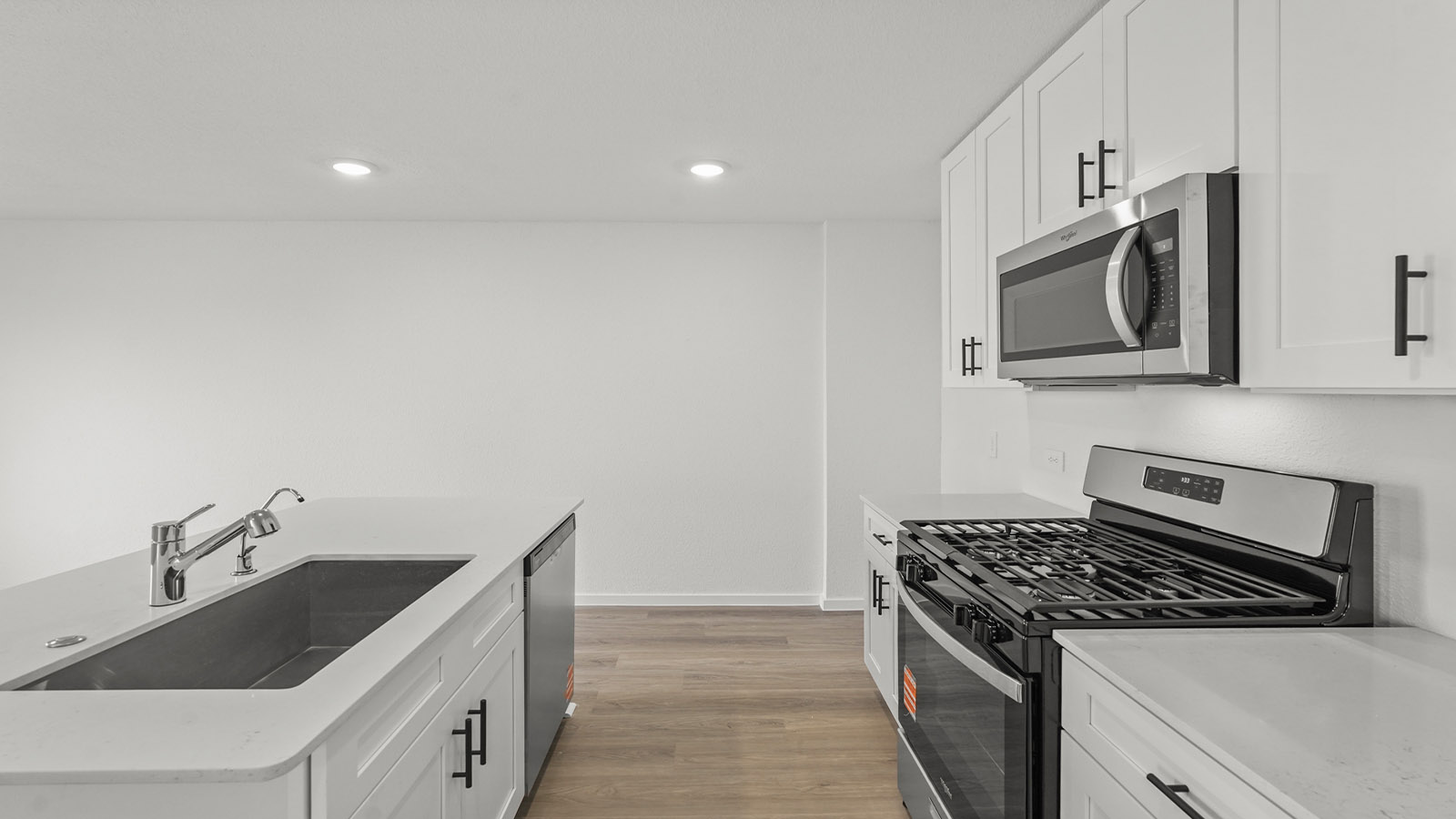 open concept living and ding area with vinyl floring, quartz countertops, and large windows