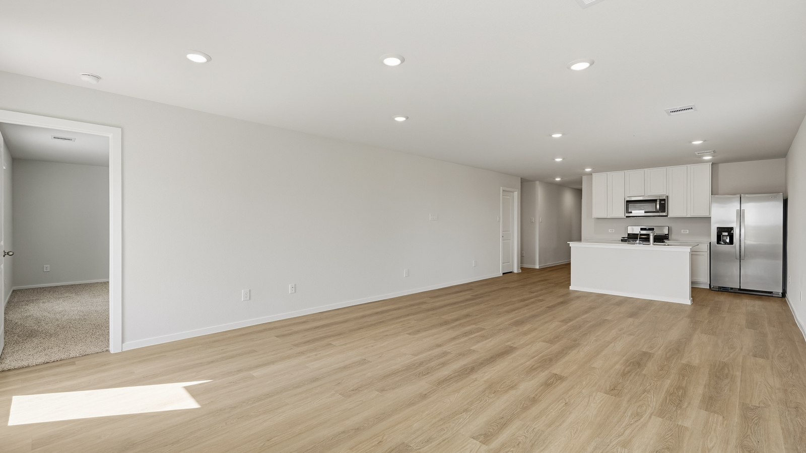 open concept living and dining area with vinyl flooring