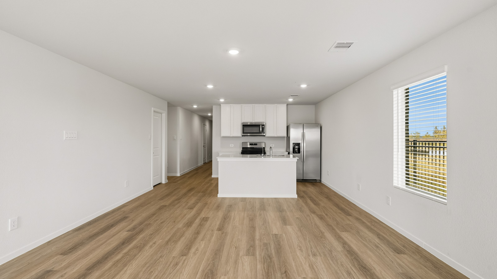 open concept living and dining area with vinyl flooring