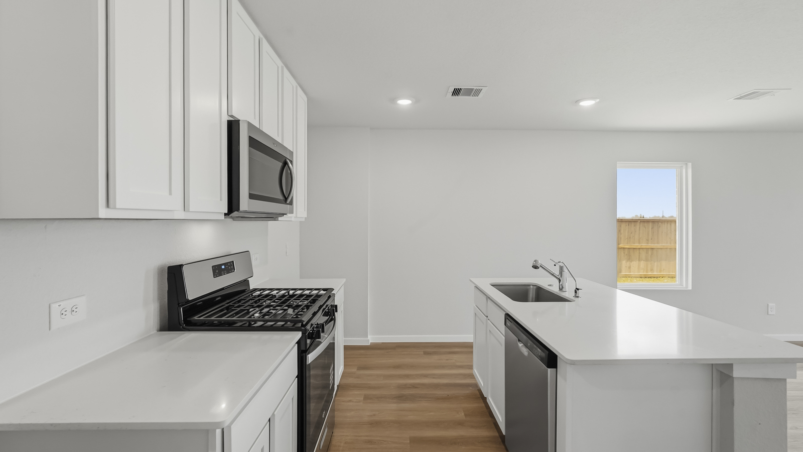 open concept living nd dining area with vinyl flooring and large windows in Katy, TX