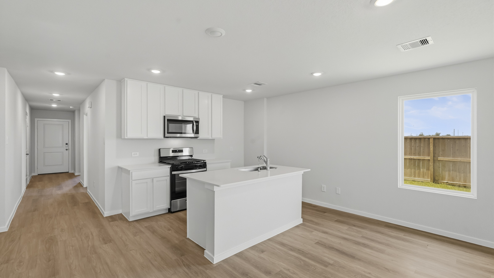 open concept living nd dining area with vinyl flooring and large windows in Katy, TX