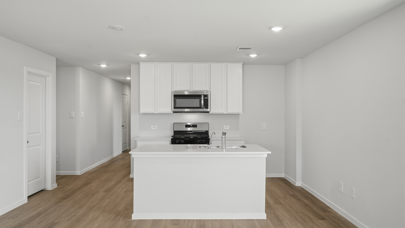 open concept living nd dining area with vinyl flooring and large windows in Katy, TX