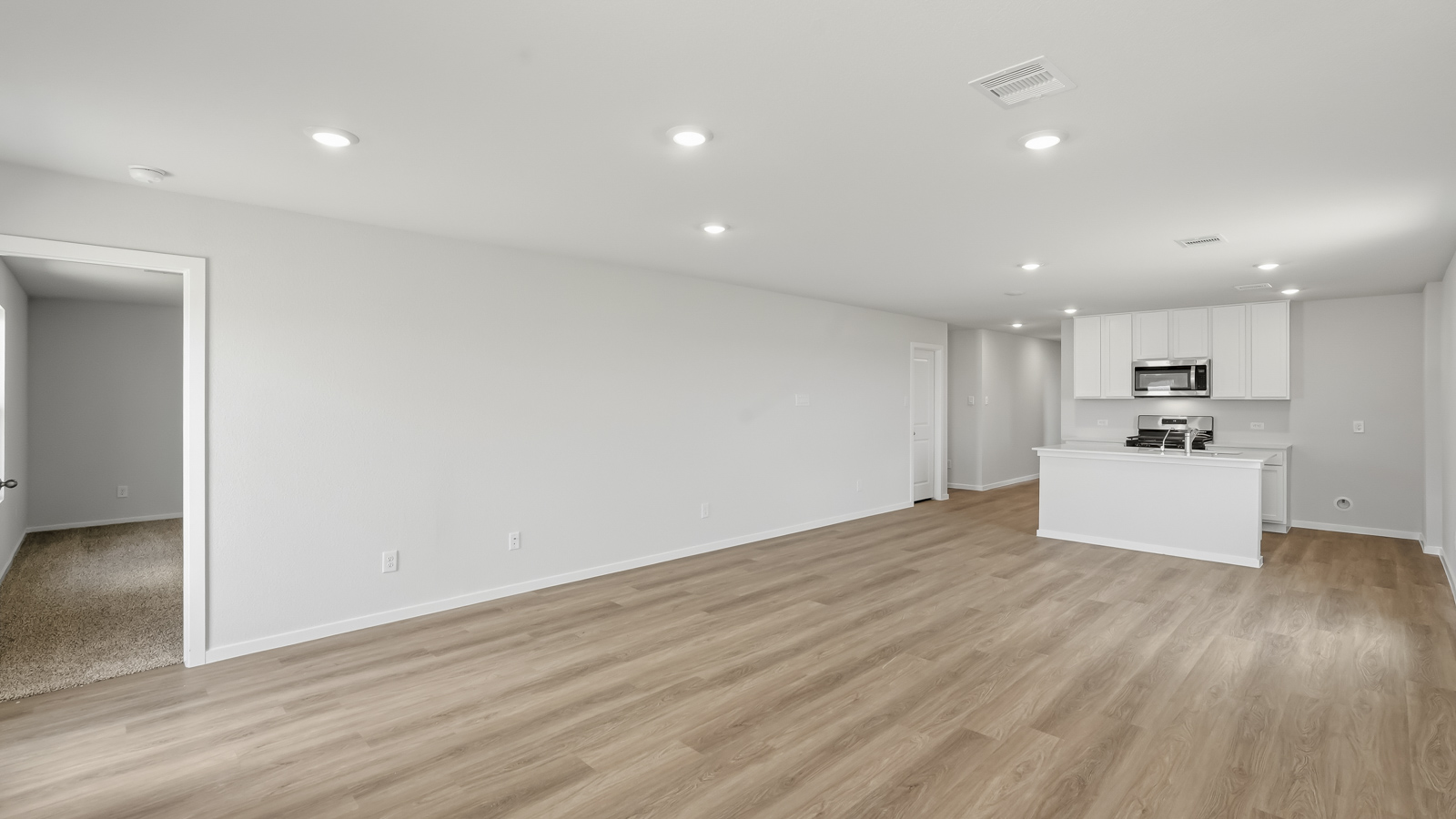 open concept living nd dining area with vinyl flooring and large windows in Katy, TX