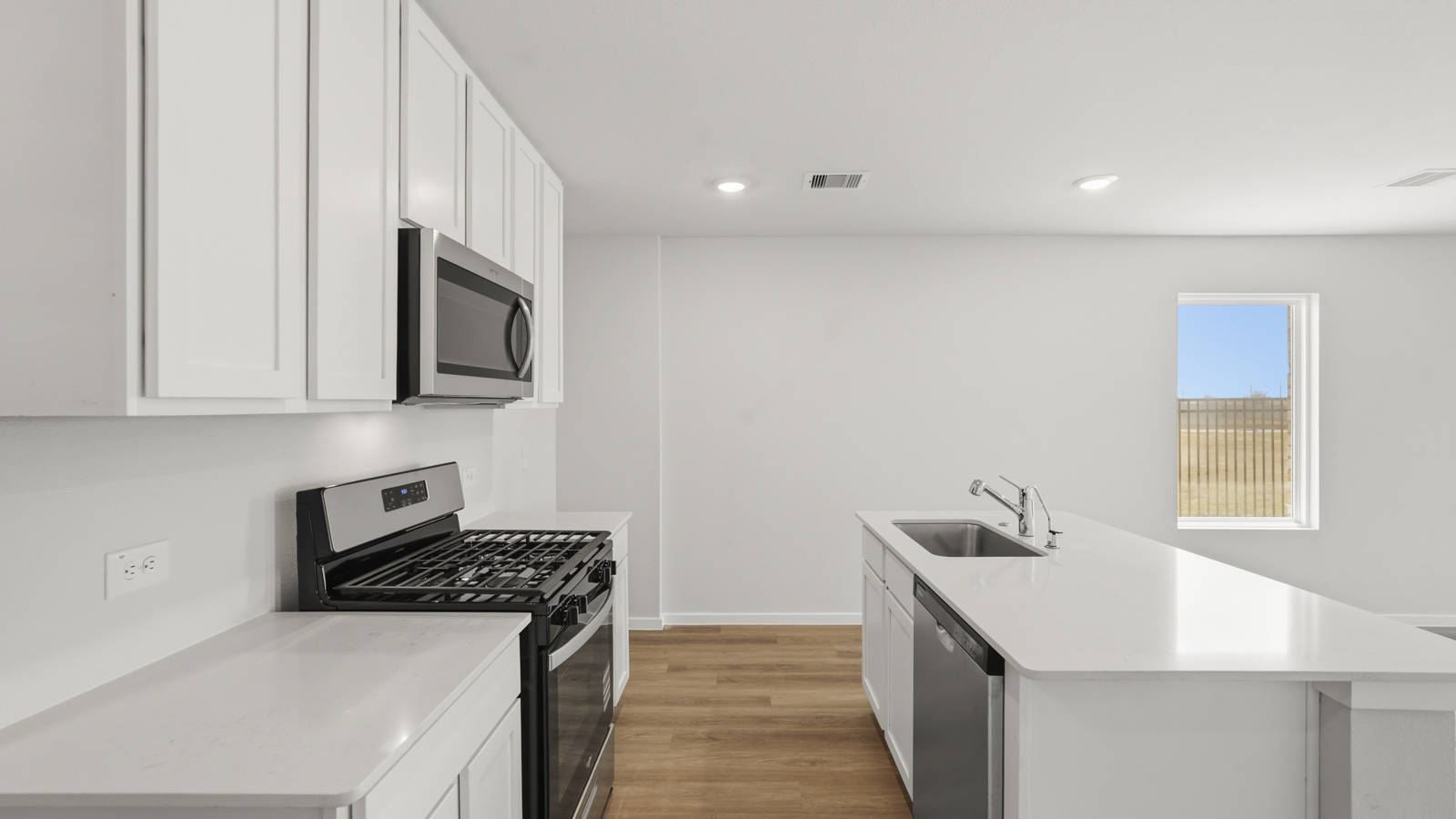 open concept living and dining area with vinyl floorin, quartz countertops, and large windows