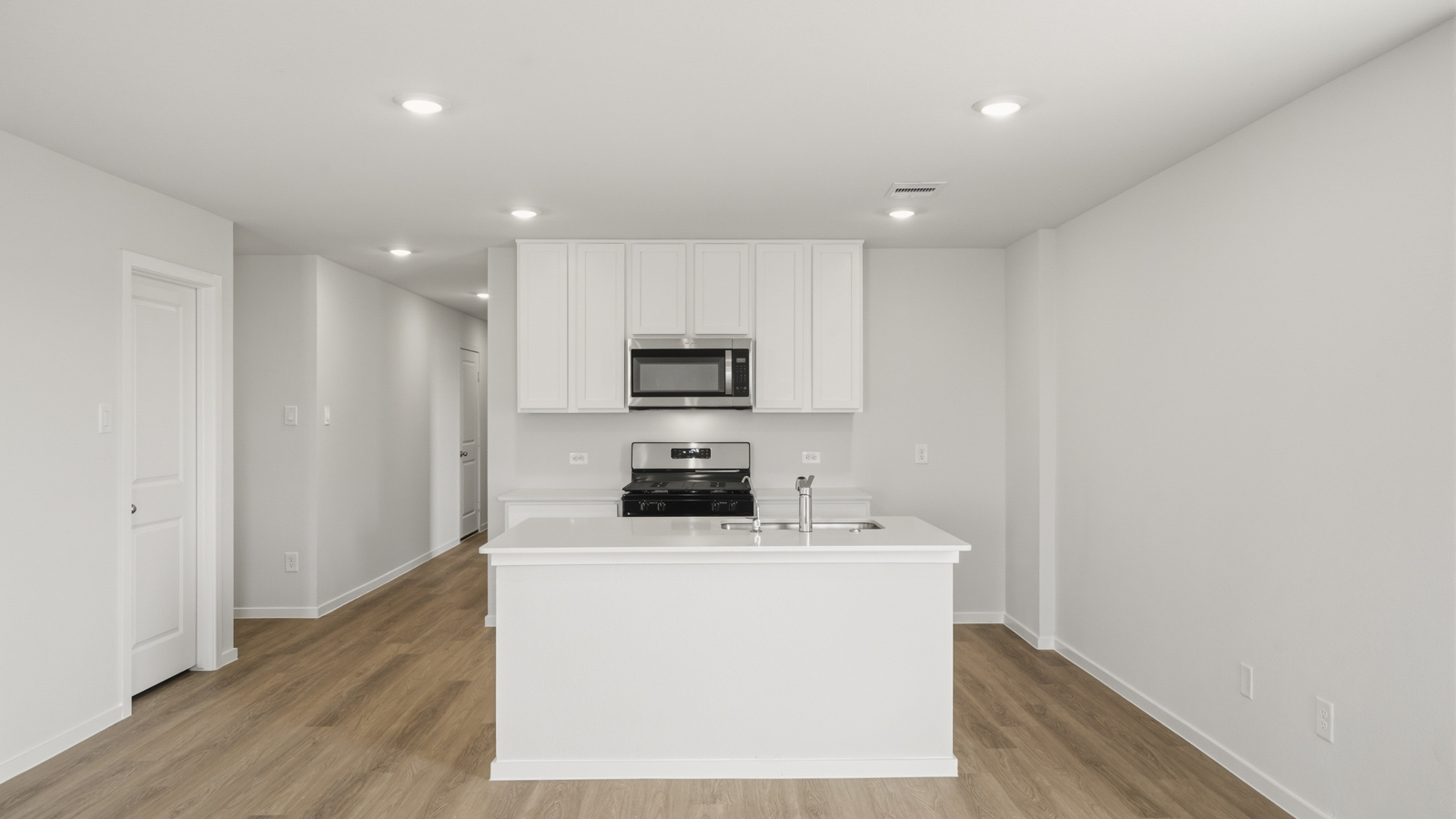 open concept living and dining area with vinyl floorin, quartz countertops, and large windows