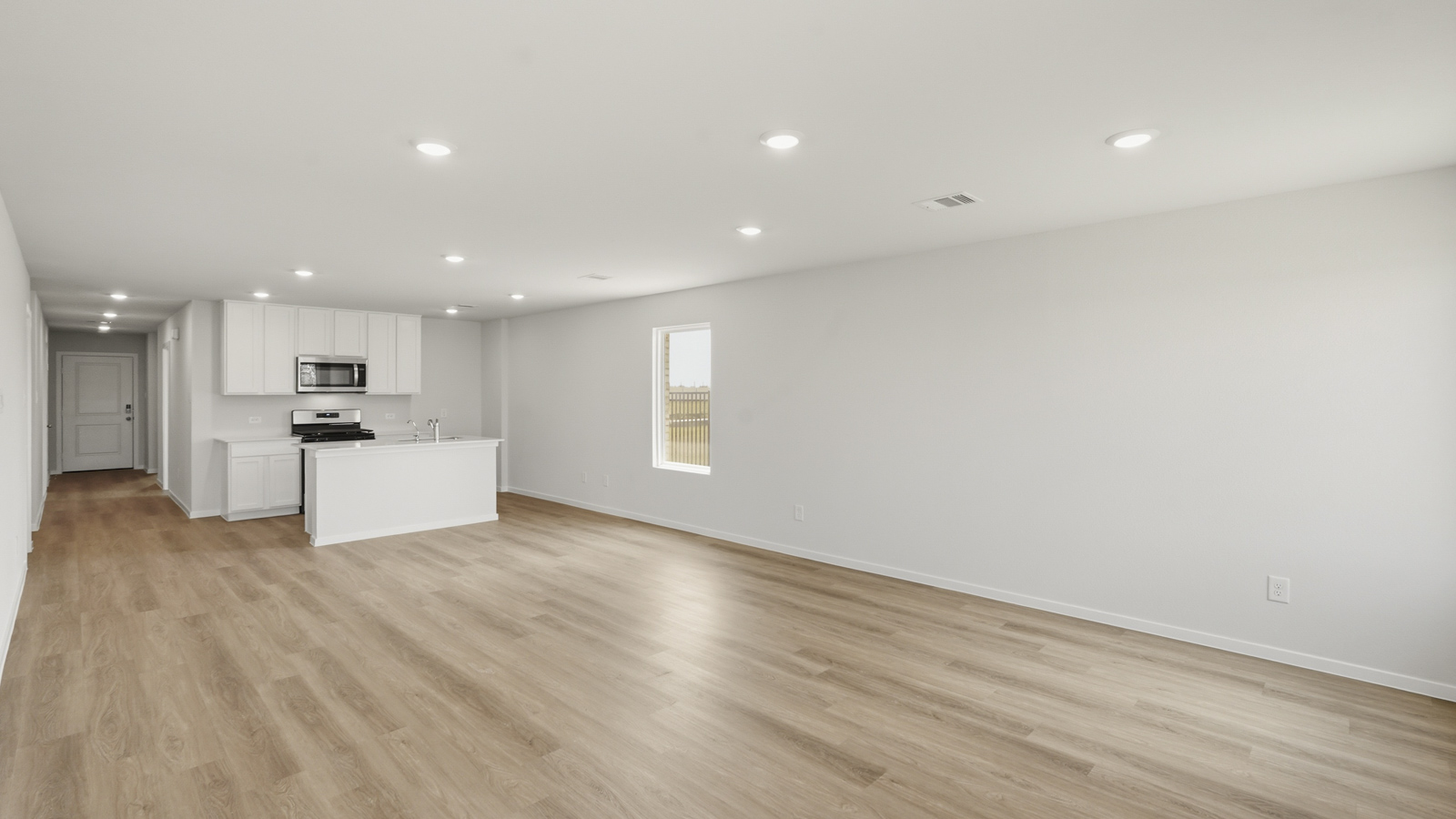 open concept living and dining area with vinyl floorin, quartz countertops, and large windows