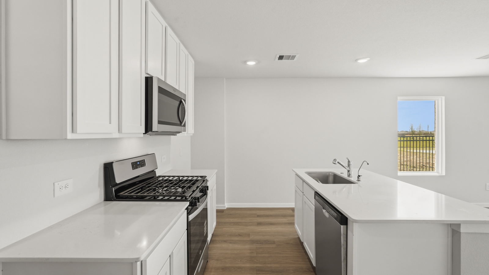 open concept living and dining area with vinyl flooring, stainless steel appliances, and quartz countertops in Katy, TX