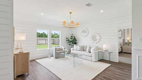 open concept living area with vinyl flooring and large windows