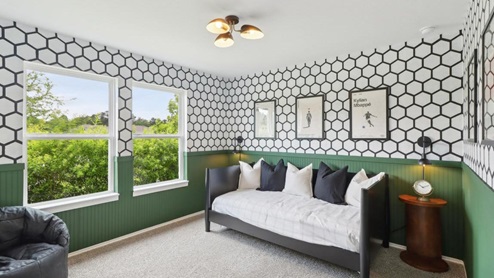 secondary bedroom with carpet flooring and large windows