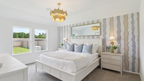 primary bedroom with carpet flooring and large windows