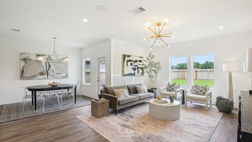 open concept living area with vinyl flooring and large windows