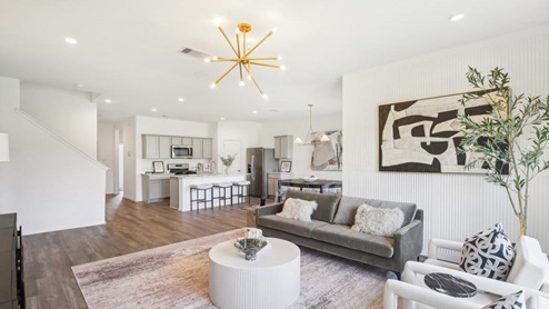 open concept living area with vinyl flooring and large windows