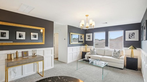 secondary bedroom with carpet flooring and large windows