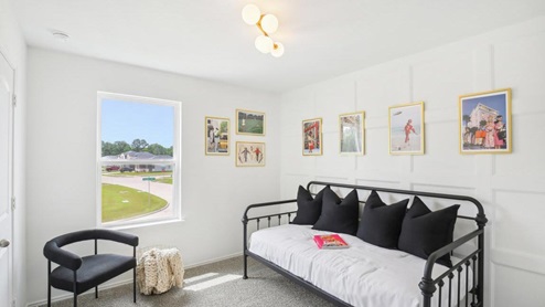 secondary bedroom with carpet flooring and large windows