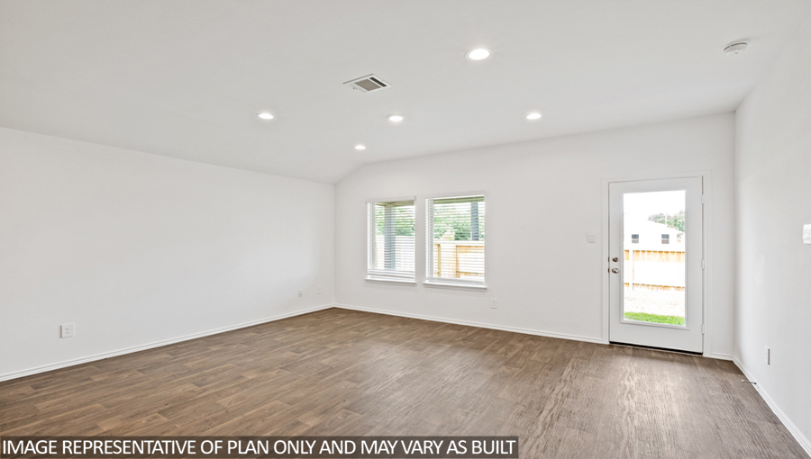 Spacious living area with vinyl flooring