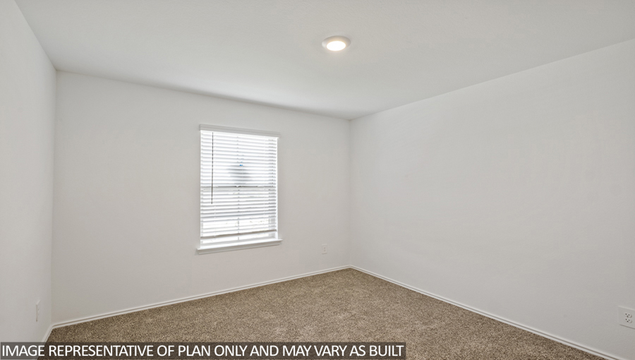 Secondary bedroom with carpet flooring