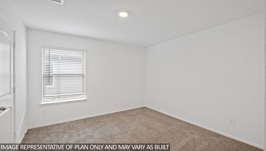 Secondary bedroom with carpet flooring