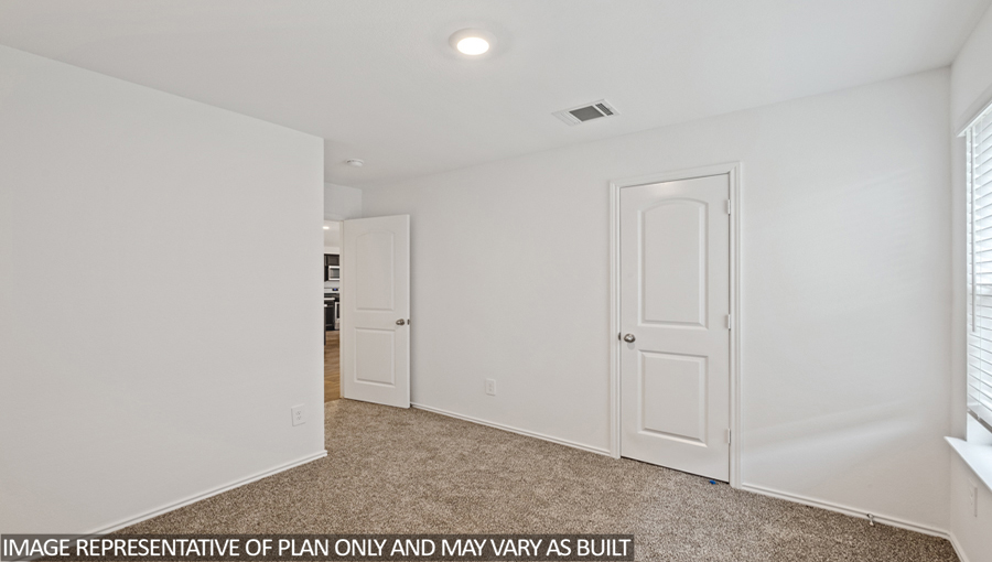 Secondary bedroom with carpet flooring